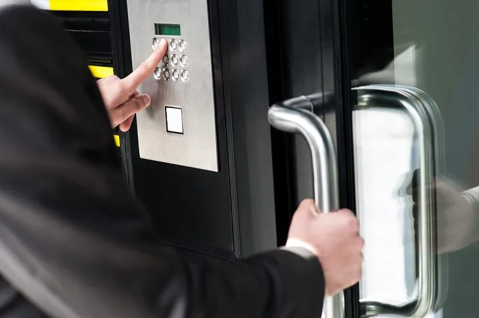Man entering security code to unlock the door Access Control System Installation In Los Angeles, Onboard IT Tech